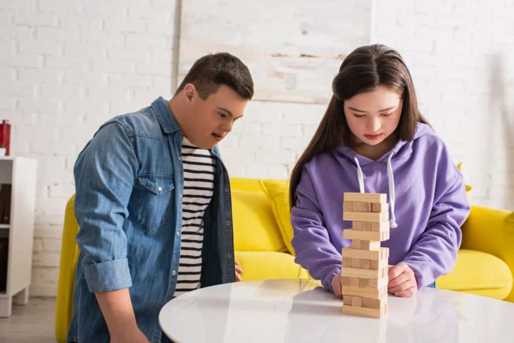 Two disabled friends with down syndrome playing jenga